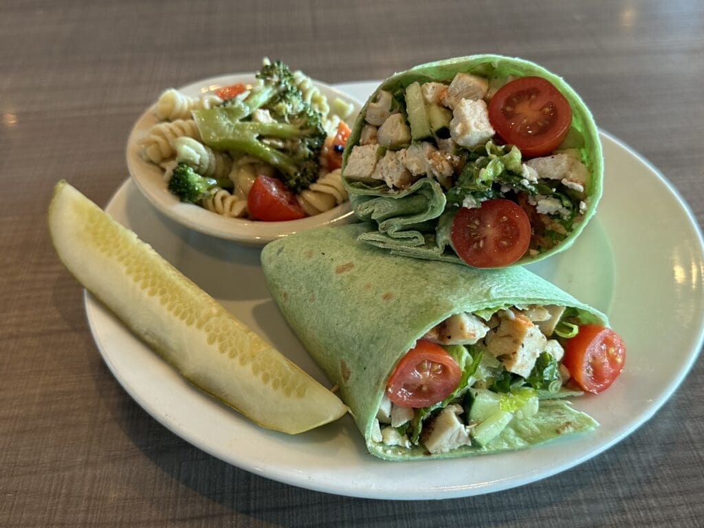 Asian Chicken Wrap served with pasta salad and a kosher dill pickle at Miracle Mile Deli in Phoenix.