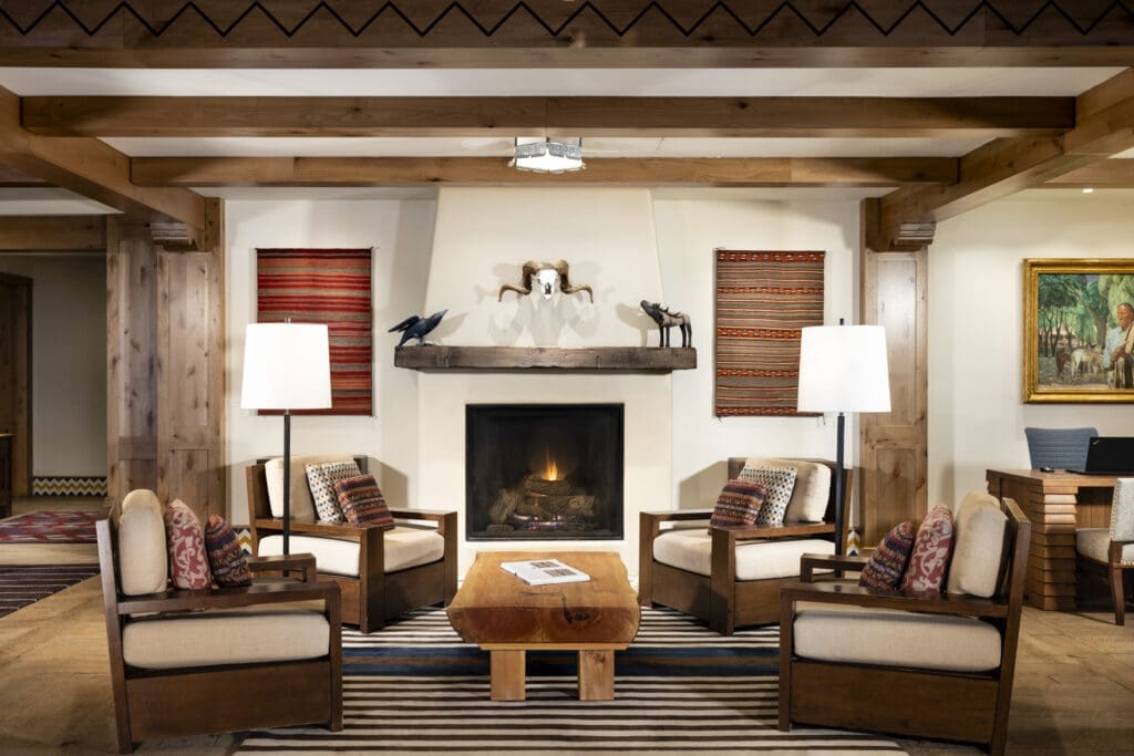 Interior lobby seating area with fireplace inside The Blake at Taos Ski Valley.