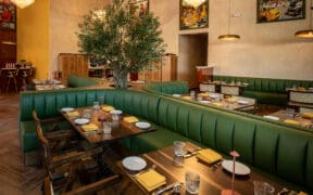 Curved green booth seating and contemporary dining room at NADU Phoenix inside Desert Ridge Marketplace.