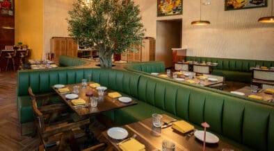 Curved green booth seating and contemporary dining room at NADU Phoenix inside Desert Ridge Marketplace.