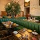 Curved green booth seating and contemporary dining room at NADU Phoenix inside Desert Ridge Marketplace.