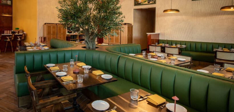 Curved green booth seating and contemporary dining room at NADU Phoenix inside Desert Ridge Marketplace.