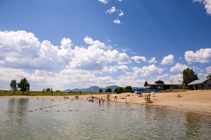 Families enjoy swimming and relaxing at Boulder Reservoir on a sunny summer day.