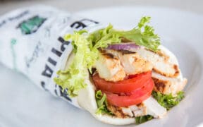 Roasted Shawarma Pita from Pita Jungle filled with grilled chicken, tomatoes, lettuce and Mediterranean-inspired ingredients.