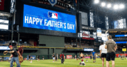 Families play catch on the field at Chase Field before an Arizona Diamondbacks Father's Day game.