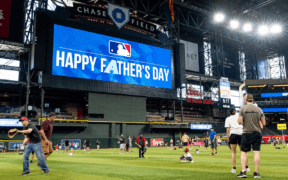 Families play catch on the field at Chase Field before an Arizona Diamondbacks Father's Day game.