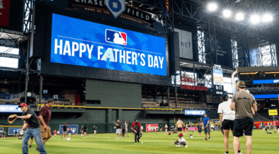 Families play catch on the field at Chase Field before an Arizona Diamondbacks Father's Day game.