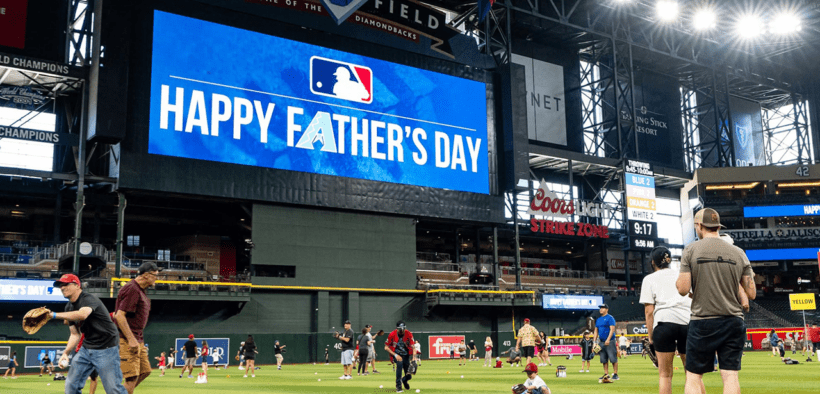 Families play catch on the field at Chase Field before an Arizona Diamondbacks Father's Day game.