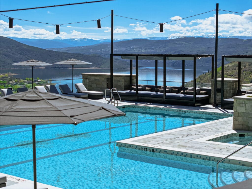 Resort pool overlooking Jordanelle Reservoir and mountain landscapes at Grand Hyatt Deer Valley in Park City, Utah.