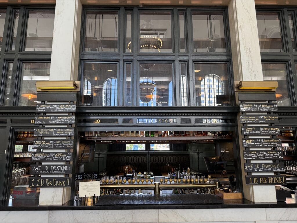The front long-pained window and bar area of Terminal Bar inside Denver Union Station.