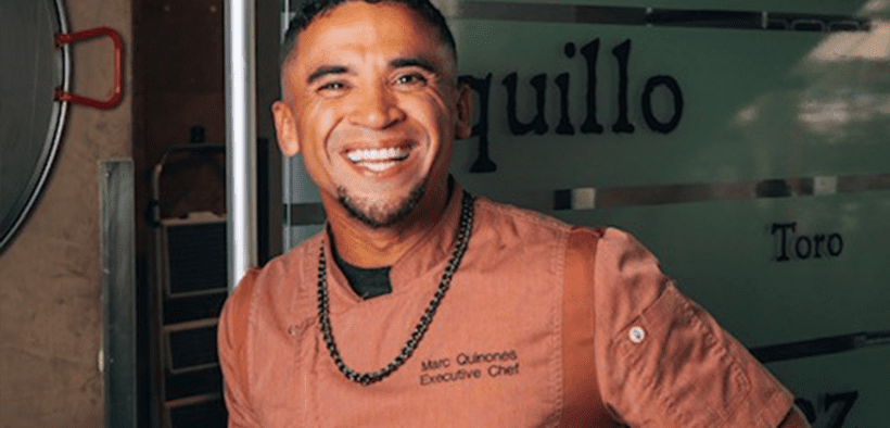 Chef Marc Quiñones smiles while standing inside La Fonda on the Plaza in Santa Fe, New Mexico.