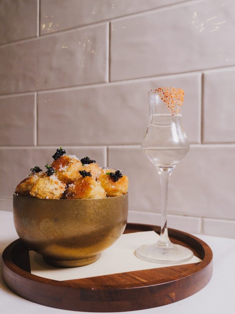 Caviar-topped tater tots served with a chilled vodka shot at Little Rich Girl cocktail bar in Flagstaff.
