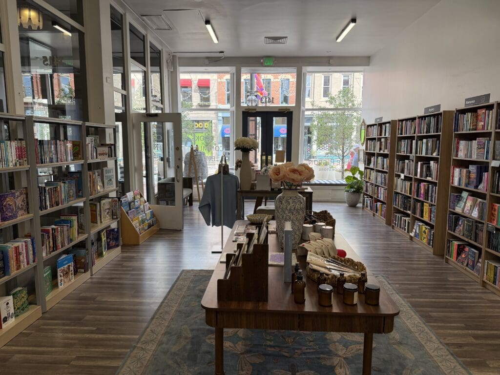Interior of Little Blue Pigeon bookstore with bookshelves, displays and natural light.