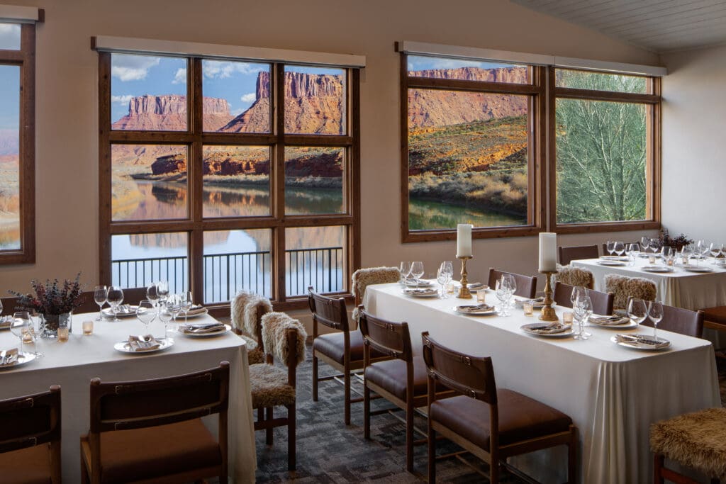 Dining room at Red Cliffs Lodge Moab overlooking the Colorado River and towering red rock canyon walls.
