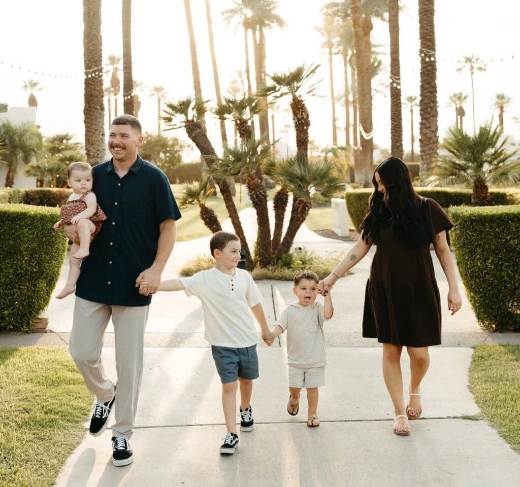A family walks together through the grounds of The Wigwam Golf Club in Litchfield Park, Arizona.