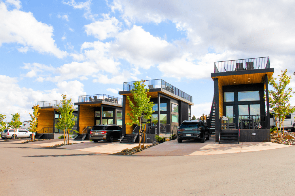 Modern Village Camp Flagstaff cabins with rooftop decks and private parking spaces.