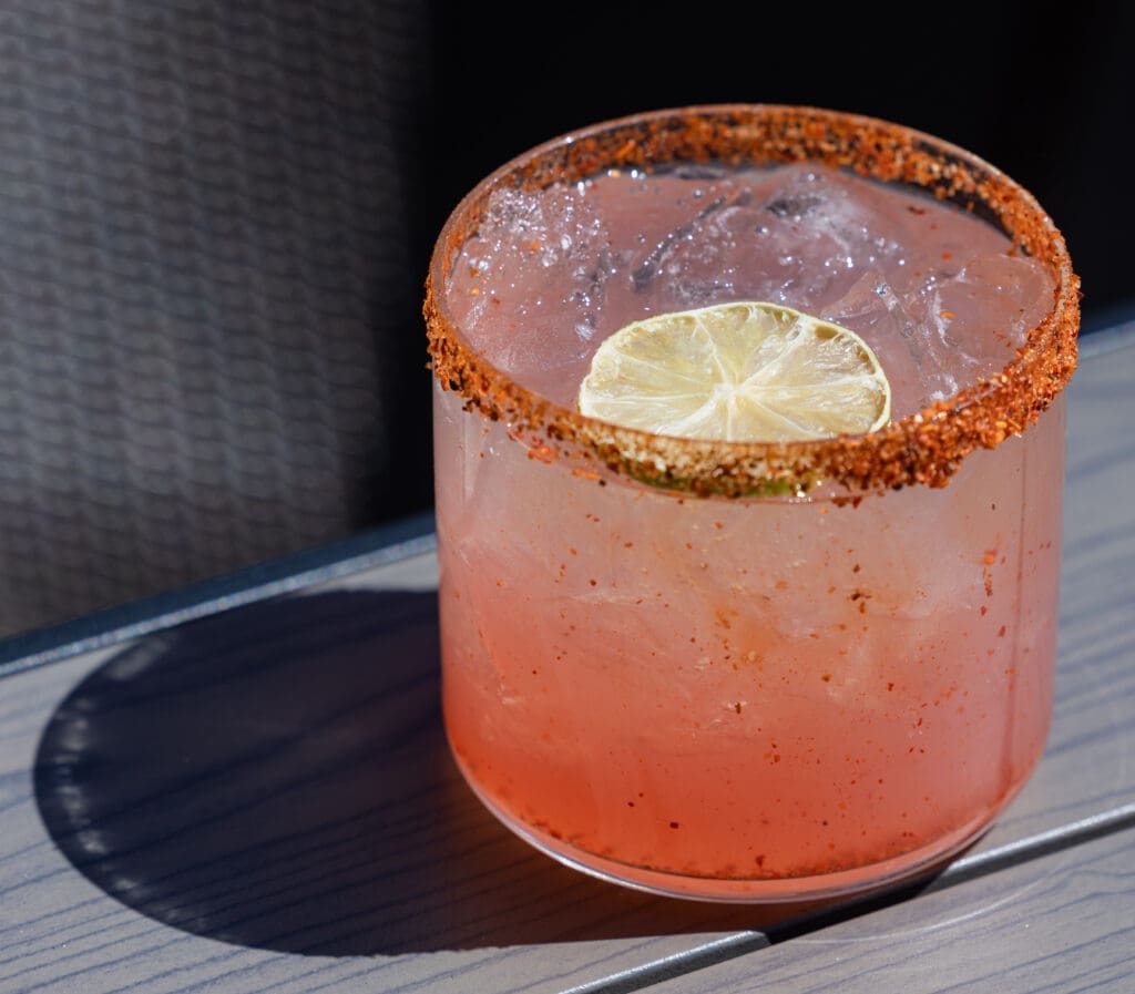 Handcrafted cocktail with lemon garnish served at CAYA restaurant in Edwards, Colorado.