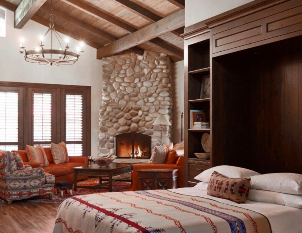 Interior of the Jackson House luxury suite at Alisal Ranch in Santa Ynez Valley, California, featuring a stone fireplace and Western-inspired décor.