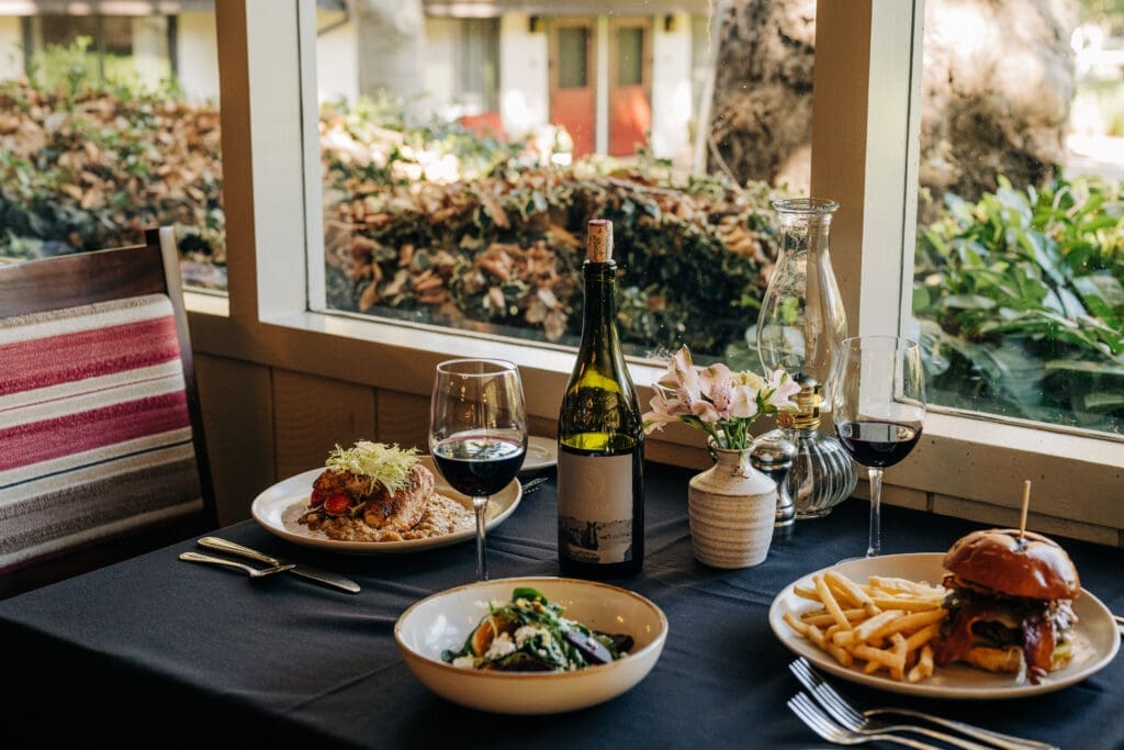 Dining room table featuring gourmet entrees, wine and seasonal dishes at Alisal Ranch.