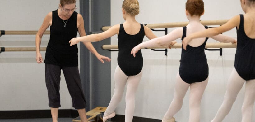 Ballet instructor teaching young dancers during class at The School of Ballet Arizona's North Central Phoenix campus.