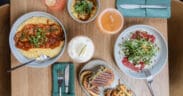 Seasonal dishes, cocktails and handcrafted beverages on a table at CAYA restaurant in Edwards, Colorado.