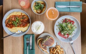 Seasonal dishes, cocktails and handcrafted beverages on a table at CAYA restaurant in Edwards, Colorado.