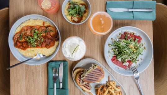 Seasonal dishes, cocktails and handcrafted beverages on a table at CAYA restaurant in Edwards, Colorado.