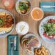 Seasonal dishes, cocktails and handcrafted beverages on a table at CAYA restaurant in Edwards, Colorado.