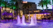 Harrah's Southern California Resort exterior at dusk with illuminated fountains and palm trees in Funner, California.