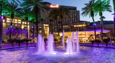 Harrah's Southern California Resort exterior at dusk with illuminated fountains and palm trees in Funner, California.