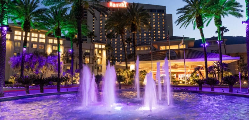 Harrah's Southern California Resort exterior at dusk with illuminated fountains and palm trees in Funner, California.