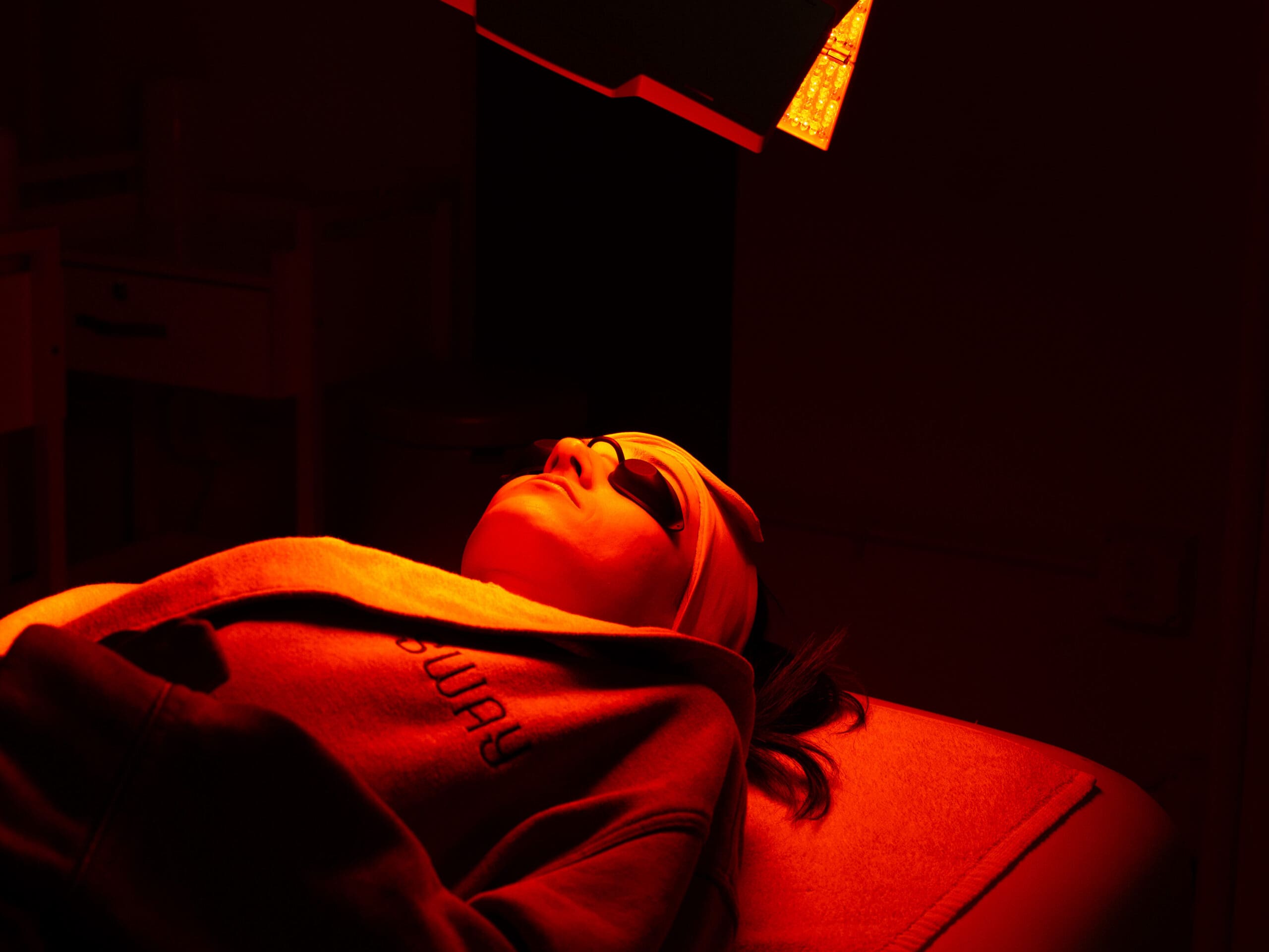 Guest receiving LED light therapy during a wellness treatment at Sway Wellness Spa in Denver.