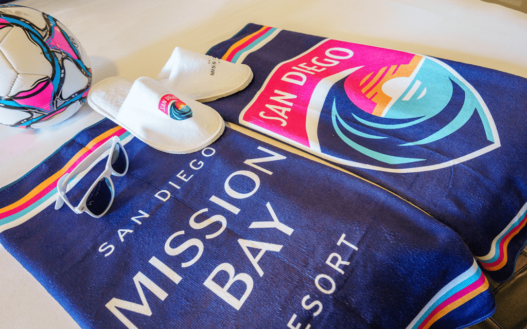 San Diego Wave FC blanket, soccer ball, slippers and resort amenities inside the themed hotel suite.