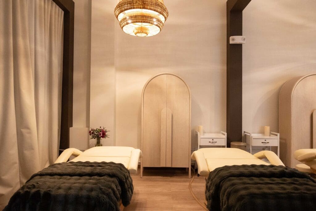Couples massage room at Sway Wellness Spa in Denver with two massage tables and calming décor.