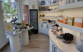 Boutique retail area inside Sway Wellness Spa in Denver's Larimer Square featuring skincare products and wellness items.