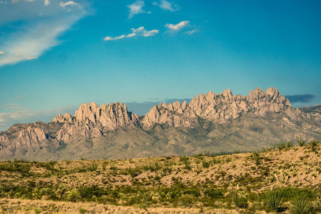 New Mexico's Organ Mountains with a blue-sky backdrop and desert landscape.