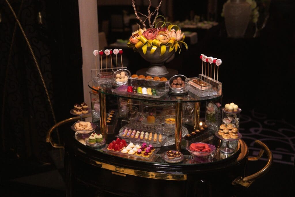 An elaborate dessert cart at Restaurant de Joël Robuchon in Las Vegas displays colorful pastries, macarons, chocolates and other confections.