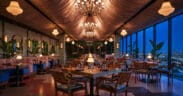 Oleander dining room with chandeliers and panoramic Los Angeles views at The Sun Rose West Hollywood.