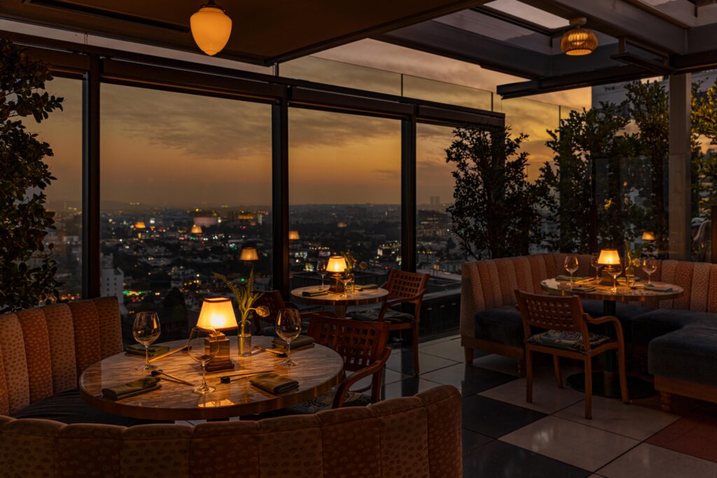 Oleander rooftop dining room at sunset overlooking Los Angeles from The Sun Rose West Hollywood.