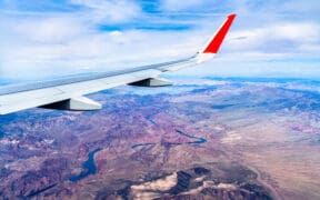 An airplane wing from a plane flying above the Colorado River in Arizona and Nevada.