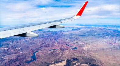 An airplane wing from a plane flying above the Colorado River in Arizona and Nevada.