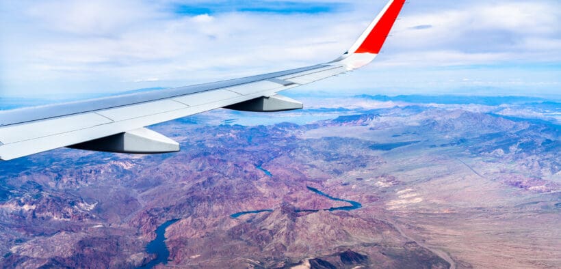 An airplane wing from a plane flying above the Colorado River in Arizona and Nevada.