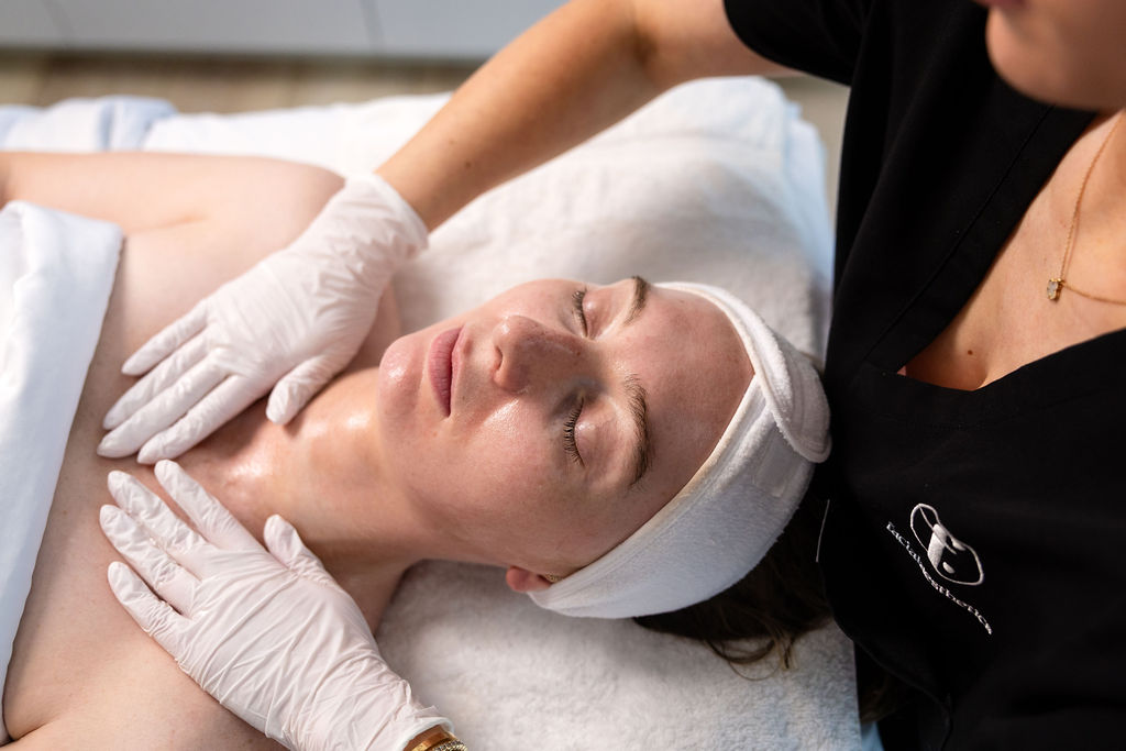 Patient receives a relaxing facial skincare treatment from a Facial Aesthetics provider.