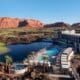 An aerial view of the Black Desert Resort with guest building, pool and Zion mountains in the background.