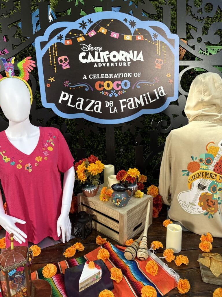 Plaza de la Familia “Coco” display with colorful merchandise, marigolds and decor at Disney California Adventure Park.