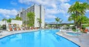 Outdoor swimming pool and hot tub surrounded by palm trees at Hilton Irvine in Orange County, California.