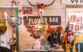 Colorful flowers, a longhorn skull and Flower Bar display inside Junk Gypsy in Round Top, Texas.