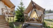 Under Canvas Kids Tent with two twin beds, a wooden deck and outdoor chairs.