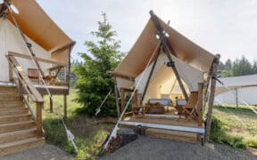 Under Canvas Kids Tent with two twin beds, a wooden deck and outdoor chairs.
