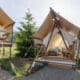 Under Canvas Kids Tent with two twin beds, a wooden deck and outdoor chairs.